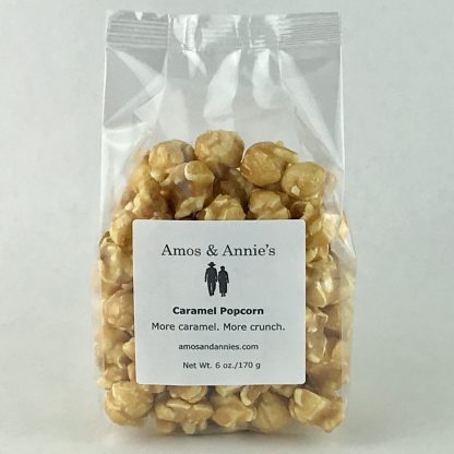 Caramel popcorn in a clear bag setting on a white background