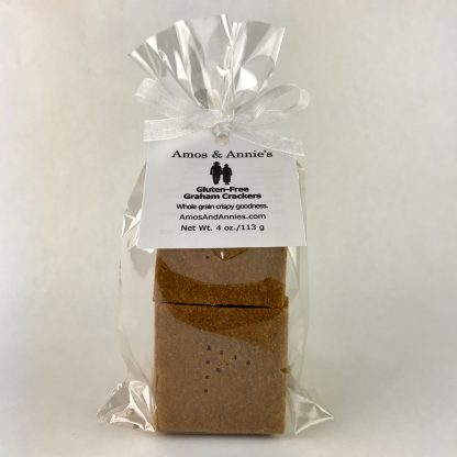 Twelve gluten-free graham crackers packaged in a clear. The bag is tied with a white organza ribbon and includes a hangtag. The bag is setting on a white background.