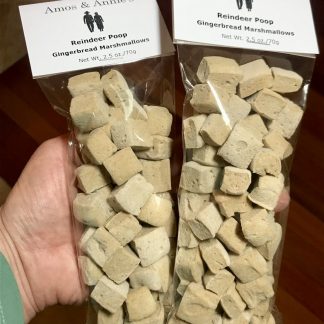 Miniature gingerbread marshmallows are packaged in slim cellophane bags. A white card is attached to the top of the bags identifying the flavor of the marshmallows. They are also given the cute name of "reindeer poop".